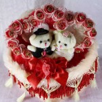 Beautiful Love Couple Teddy Bears Sitting on a Decorated Heart Cushion